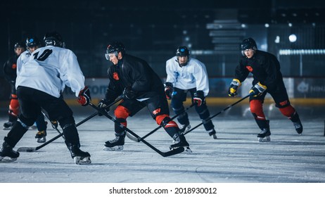 Dark Ice Hockey Rink Arena: Young Players Training, Learning Stick And Puck Handling. Athletes Learn How To Dribble, Attack, Defend, Protect, Possesion, Drive The Puck.