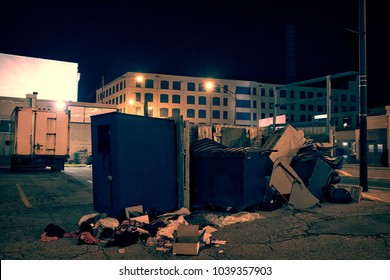 Dark Industrial Urban City Street Corner With Trash And Garbage Dumpsters At Night