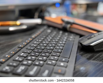 dark keyboard on the table with a mouse