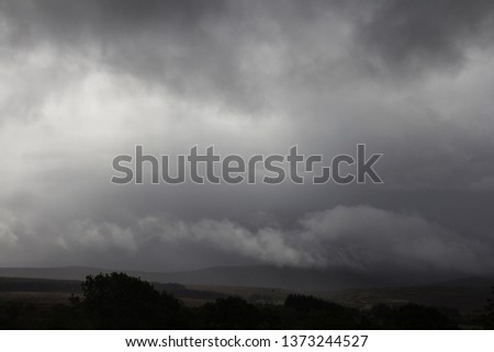 Dark landscape under dramatic storm clouds. Troutbeck, Lake District, UK. October. Low horizon.