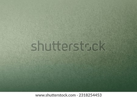 Dark leafy green color gradation light tone paint on environmental friendly craft recycled cardboard box paper texture background with minimal design and space