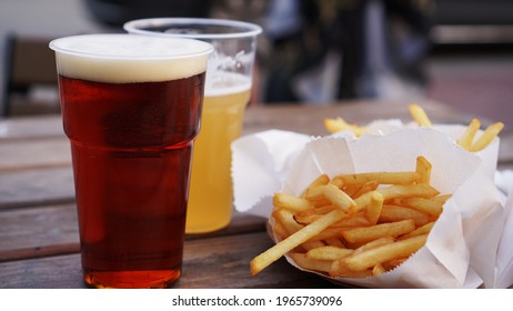 Dark And Light Beer And Fries On A Wooden Table. Food Court. Takeaway Food, Food Festival. Unhealthy Food Concept