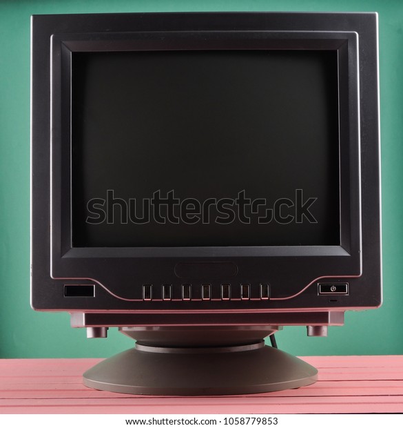 Dark lighting of a retro TV set on a blue\
pastel background\
