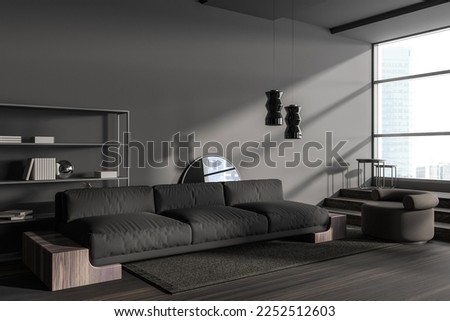 Dark living room interior with sofa and armchair, side view on carpet hardwood floor. Minimalist shelf with art decoration and panoramic window on city view. 3D rendering