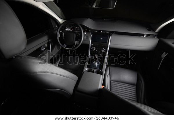 Dark luxury car Interior. Front\
seats of premium suv Leather panels. the view from the\
ceiling\
\
