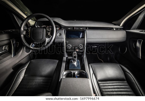 Dark luxury car Interior. Front\
seats of premium suv Leather panels. the view from the\
ceiling\
\
