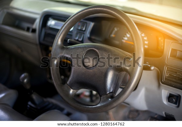 Dark luxury car\
Interior , steering wheel, shift lever and dashboard. Car interior\
luxury on blur background.