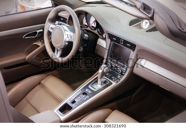 Dark luxury car Interior - steering wheel,\
shift lever and dashboard
