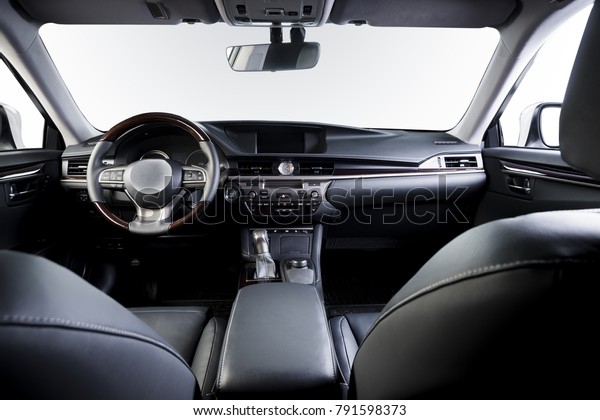 Dark luxury car\
Interior - steering wheel, shift lever and dashboard. Car inside.\
Beige comfortable seats, steering wheel, dashboard, climate\
control, speedometer,\
display.