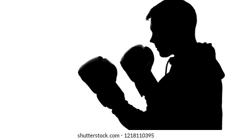 Dark male silhouette in hood attacking opponent, shadow-boxing self-defense - Powered by Shutterstock