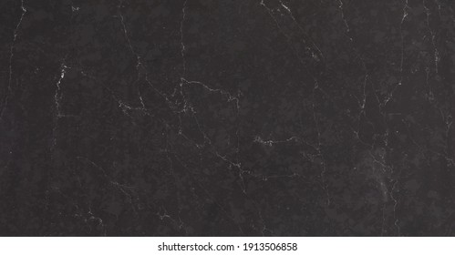 A Dark Marble Looking Quartz Slab That Contains A Two-toned Charcoal Grey Background With Soft Light Grey Subtle Veins.