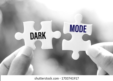 Dark mode (displays light text on a dark background) word on white jigsaw is connect - idea match concept.