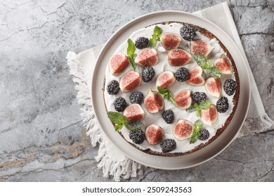 Dark mood cake with Figs, Blackberry and Ricotta Cake closeup on the plate on the table. Horizontal top view from above
 - Powered by Shutterstock