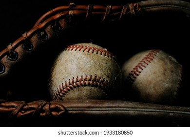 Dark And Moody Baseball Still Life With Ball And Old Used Glove For Sports Nostalgia.