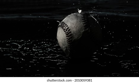 Dark Moody Baseball In Water On Black Background For Rain Concept.