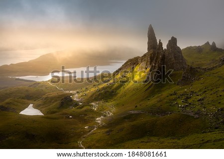 Dark and moody low clouds over the iconic Old Man of Storr on the Isle of Skye, Scotland, UK.