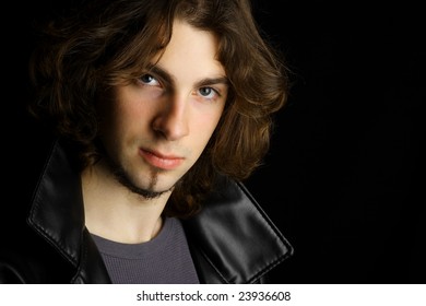 Dark Moody Portrait On An Attractive Young Man Against A Black Background