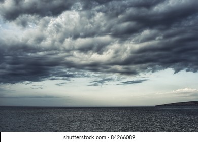 Dark Moody Sky Over The Gray Sea.