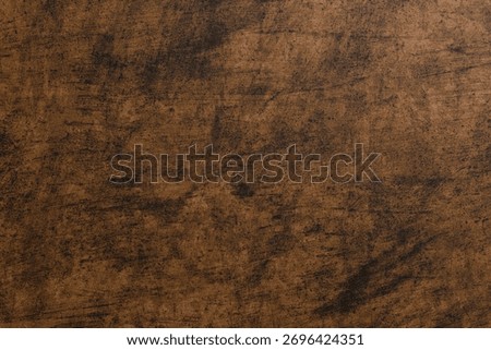 Dark, mottled brown background with subtle scratches and textures, resembling distressed wood or aged leather