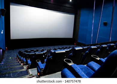 Dark Movie Theatre Interior. Screen And Chairs.