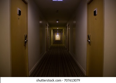 dark mysterious corridor in building, doors,  perspective, in yellow-orange tones.Thriller Concept. - Powered by Shutterstock