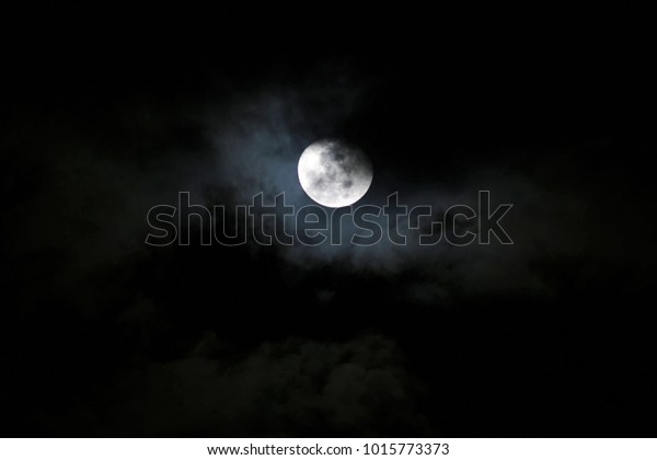 Dark night, full\
moon, cloudy middle\
ground.