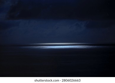 dark night lights with clouds ower the sea