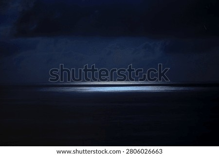 dark night lights with clouds ower the sea