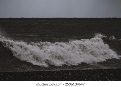 Dark ocean waves crashing on rocky shore
 Intense ocean waves break against a dark, rocky shoreline under an overcast sky, capturing the power of nature in moody tones.
 - Powered by Shutterstock