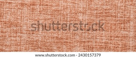 Dark orange fluffy background of soft, fleecy cloth. Texture of textile closeup