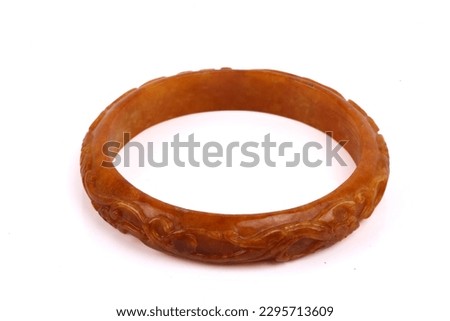 A dark orange or red or brown carved coral bracelet. Isolated on a white background