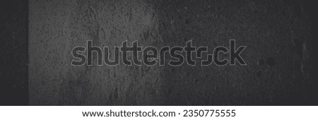 Dark panoramic background for design. Torn old faded paper wallpaper with a retro pattern. Ragged scraps of paper on a concrete wall. Shaded vintage tattered paper texture. Wide panorama with vignette