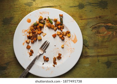 Dark Photo- Still Life. Food Scraps On A White Plate