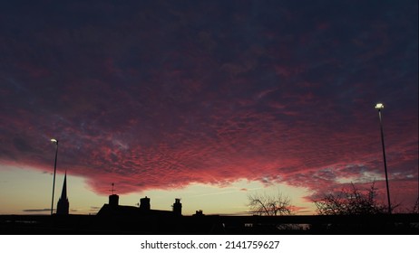 Dark Pink Clouds Hovering Over Salisbury Skyline Just After Sundown 