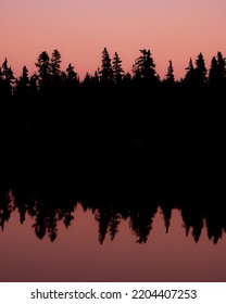 Dark Pink Moody Mysterious Reflection At Sunset On Alpine Lake Squamish Canada