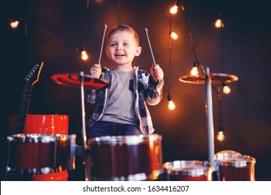 Dark Portrait Of Beautiful Boy Playing The Drums On A Black Background With Smoke.