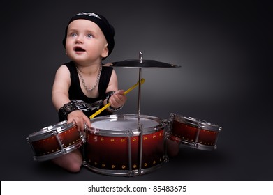 Dark Portrait Of  Beautiful Boy Playing The Drums On A Black Background