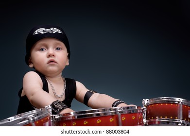 Dark Portrait Of  Beautiful Boy Playing The Drums On A Black Background