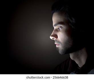 Dark Portrait Of A Face In Profile