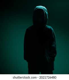 A Dark Portrait Of A Faceless Child In The Hoodie, Silhouette In The Dark Green Light Envirounment