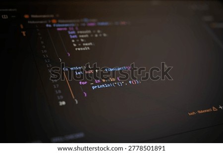 Dark programming interface with colorful source code displayed on computer monitor, symbolizing software development, coding, cybersecurity, artificial intelligence, data engineering and modern digital technology.