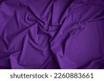 Dark purple fabric background with copy space