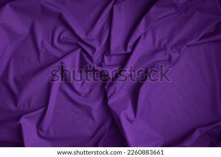 Dark purple fabric background with copy space