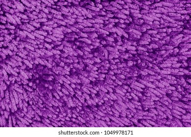 dark purple fabric doormat texture background.