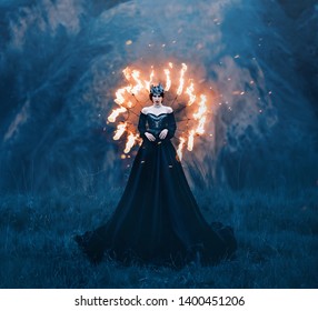 Dark Queen Of Night, Majestic Priestess In Long Black Dress With Bare Shoulders, Witch Raven In A Burning Spider Web, Powerful Devil With Metal Cold Crown On Her Head, Mistress And Fire Goddess