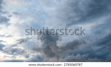 Dark rain cloud dramatic sky summer tropical thunder storm sky and fluffy black darkness cloud nearly raining cloudscape. Dark gray sky cloudy environment. Nimbus raincloud skyline climate background