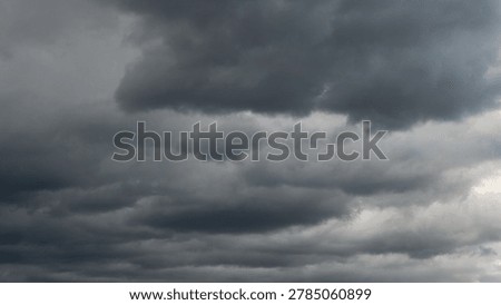 Dark rain cloud dramatic sky summer tropical thunder storm sky and fluffy black darkness cloud nearly raining cloudscape. Dark gray sky cloudy environment. Nimbus raincloud skyline climate background