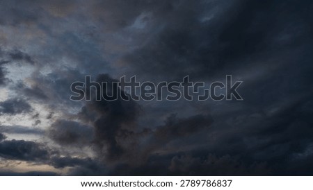 Dark rain cloud dramatic sky summer tropical thunder storm sky and fluffy black darkness cloud nearly raining cloudscape. Dark gray sky cloudy environment. Nimbus raincloud skyline climate background
