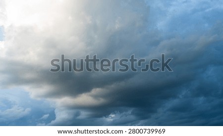 Dark rain cloud dramatic sky summer tropical thunder storm sky and fluffy black darkness cloud nearly raining cloudscape. Dark gray sky cloudy environment. Nimbus raincloud skyline climate background