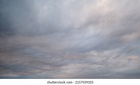 Dark rain clouds in the evening sky, timelapse. Dramatic sky with an coming cloudy cyclone of bad weather - Shutterstock ID 2157559325